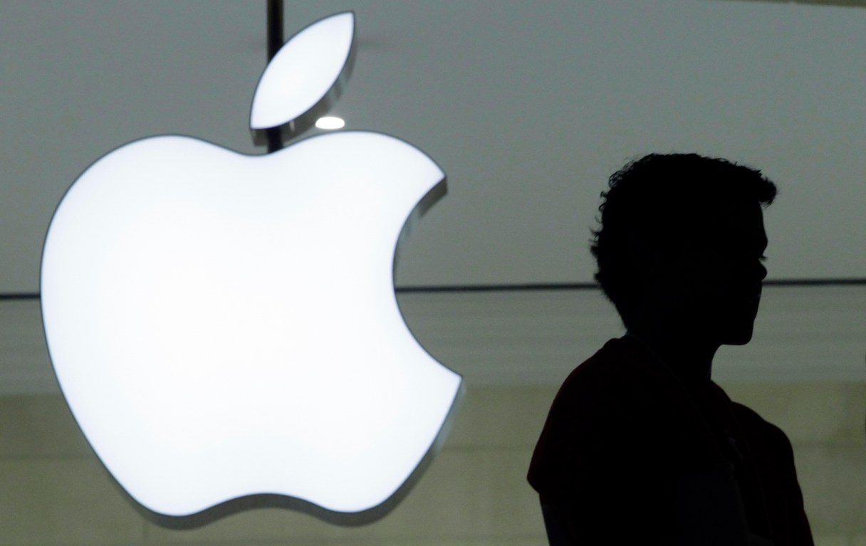 FILE - In this Wednesday, Dec. 7, 2011 file photo, a person stands near the Apple logo at the company's store in Grand Central Terminal, in New York. Apple appears poised to unveil a voice-activated, internet-connected speaker that would create a new digital pipeline into people’s homes. Tapping Apple’s Siri digital assistant, such a speaker is expected to serve as a butler as well as an outlet for listening to music. If the speculation pans out, the speaker would be Apple’s first new product since its smartwatch in 2015, Sunday, June 4, 2017. (AP Photo/Mark Lennihan, File)