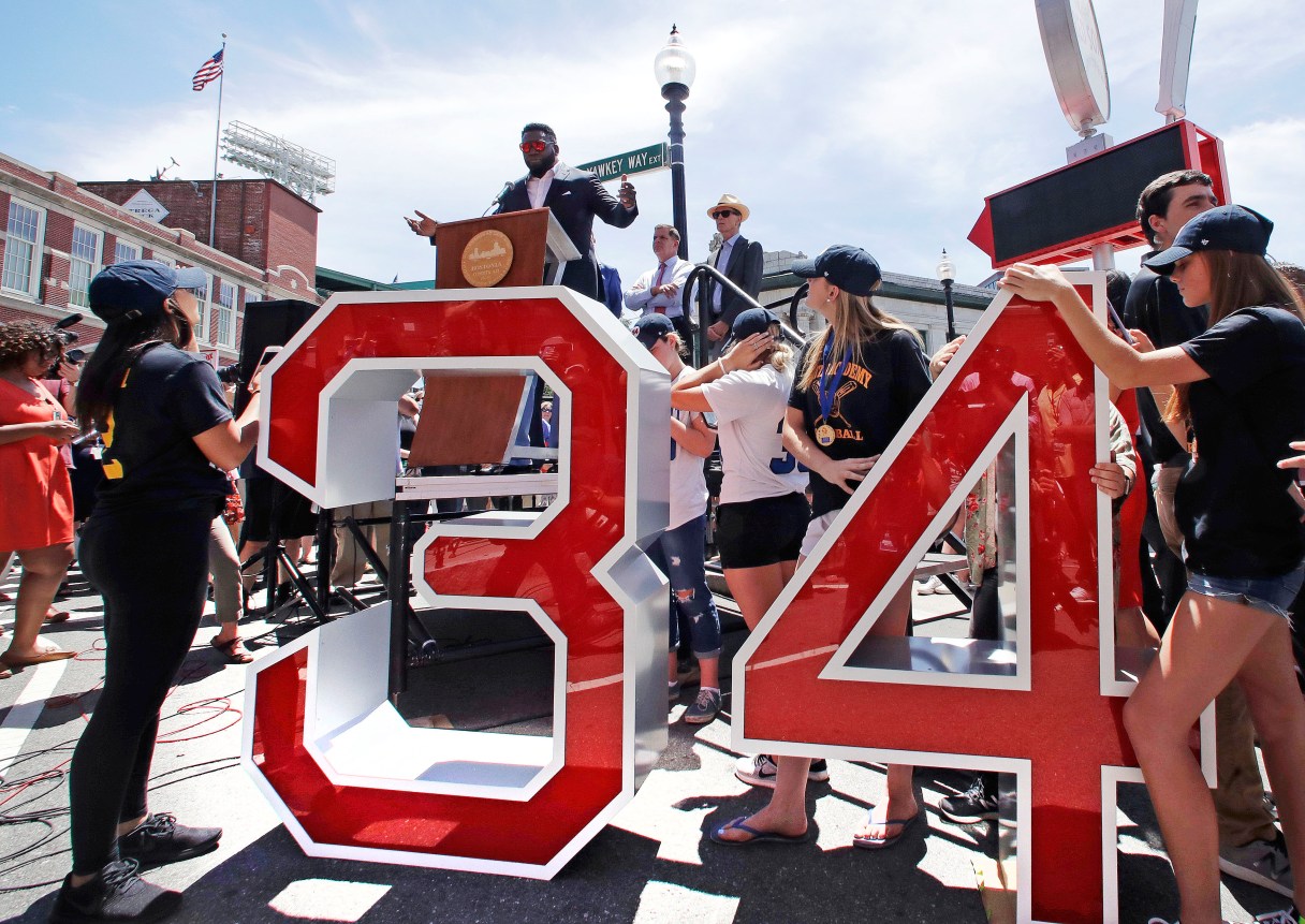 Retired Boston Red Sox designated hitter David Ortiz addresses a gathering, where part of Yawkey Way was renamed David Ortiz Drive, Thursday, June 22, 2017, outside Fenway Park in Boston. Ortiz's No. 34 will be retired in a ceremony prior to Friday night's game. (AP Photo/Charles Krupa)