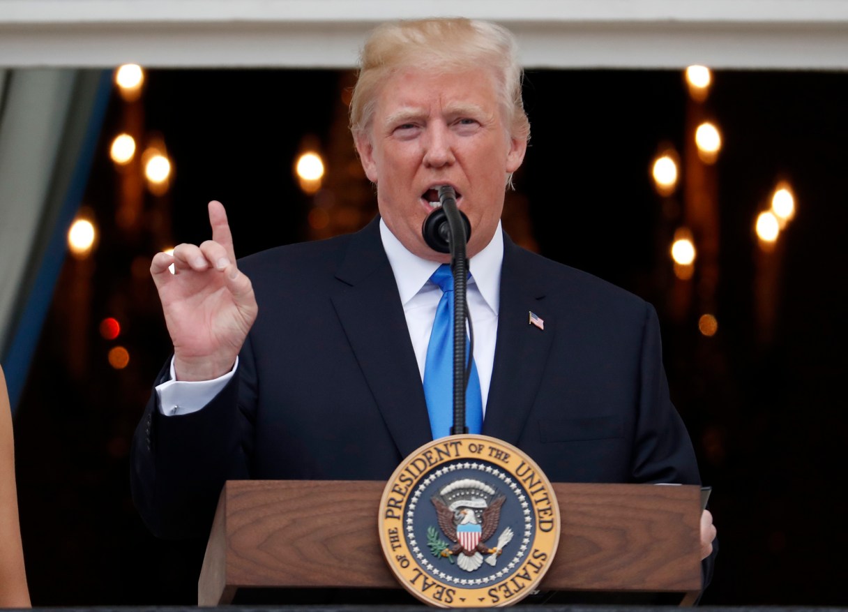 President Donald Trump speaks from the Truman Balcony at the Fourth of July picnic for military families on the South Lawn of the White House, Tuesday, July 4, 2017, in Washington. (AP Photo/Alex Brandon)
