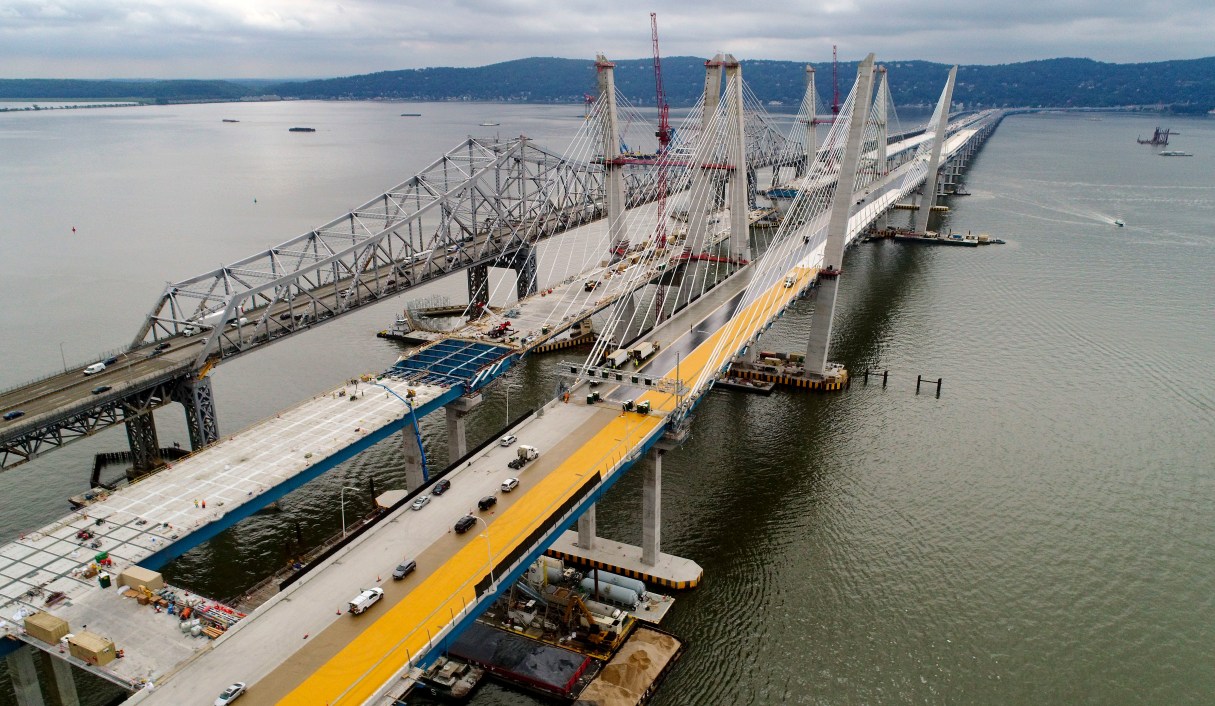 FILE- In this July 25, 2017 file photo, construction continues on the spans of the new Governor Mario M. Cuomo Bridge, right, as vehicles make their way on the the Tappan Zee Bridge over the Hudson River, near Tarrytown, N.Y. President Donald Trump’s road to getting legislation through Congress this year to restore the nation’s crumbling infrastructure appears increasingly precarious. (AP Photo/Julie Jacobson, File)