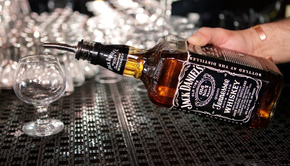 FILE - In this March 4, 2011, file photo, a bartender begins to pour a drink from a bottle of Jack Daniels at a bar in San Francisco. Brown-Forman Corp. said Wednesday, Aug. 30, 2017, its first-quarter net income rose sharply as the maker of Jack Daniel's Tennessee Whiskey reported strong sales growth across its broad portfolio of brands. (AP Photo/Paul Sakuma, File)
