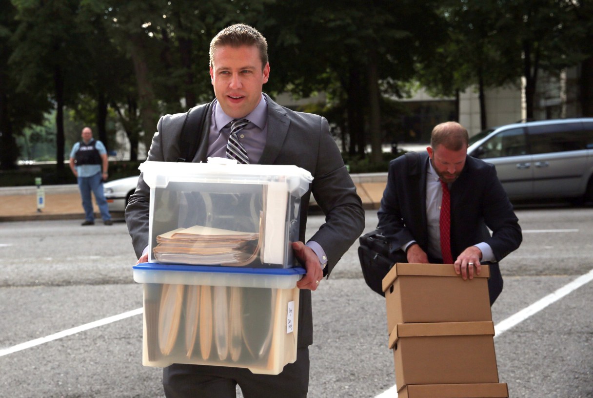 Former St. Louis city police officer Jason Stockley, 36, center, arrives with his legal team on Tuesday, Aug. 1, 2017, at the Carnahan Courthouse in St. Louis. Opening statements are planned Tuesday for Jason Stockley, who is charged with first-degree murder and armed criminal action in the 2011 death of 24-year-old Anthony Lamar Smith. (Laurie Skrivan/St. Louis Post-Dispatch via AP)