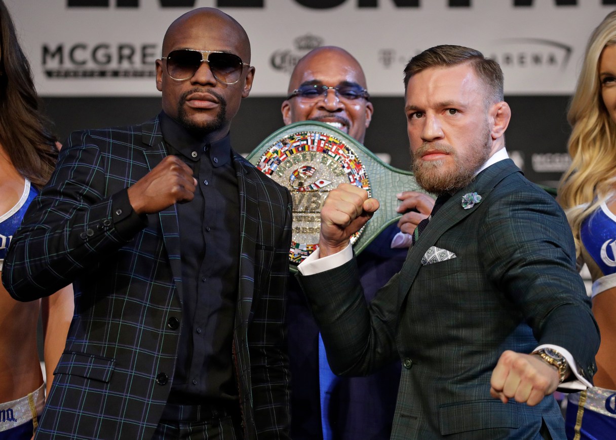 Floyd Mayweather Jr., left, and Conor McGregor pose for photographers during a news conference Wednesday, Aug. 23, 2017, in Las Vegas. The two are scheduled to fight in a boxing match Saturday in Las Vegas. (AP Photo/John Locher)