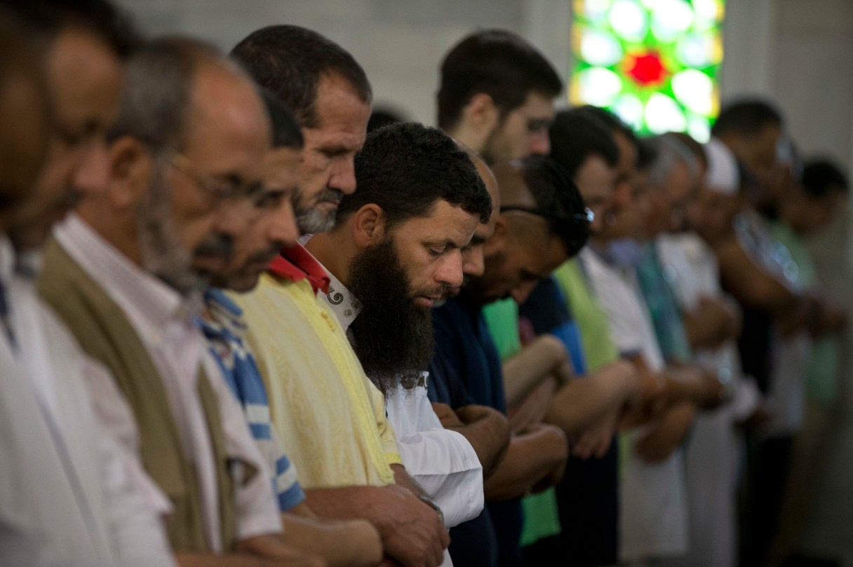 Muslim worshipers pray for the victims of the Barcelona van attacks at the main mosque in Madrid, Spain, Friday Aug. 25, 2017. The Islamic State group has claimed responsibility for the attacks on Aug. 17-18 in Barcelona and Cambrils that left 15 dead and more than 120 injured. Eight suspects are dead and four more under investigation, two of them in jail. (AP Photo/Paul White)