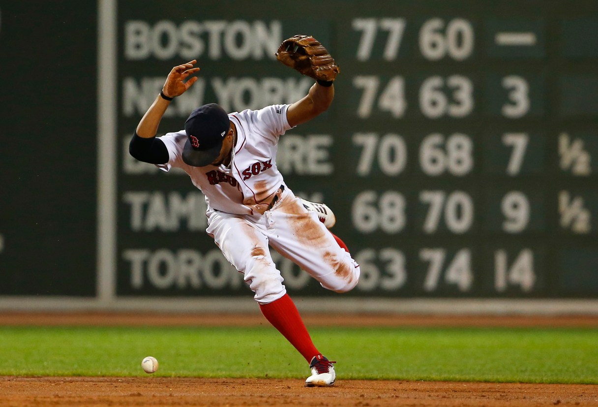 Boston Red Sox shortstop Xander Bogaerts loses the ball trying to force out a runner at second base during the second inning of a baseball game against the Toronto Blue Jays at Fenway Park in Boston, Monday, Sept. 4, 2017. (AP Photo/Winslow Townson)