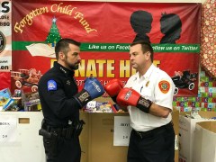 Chattanooga Police Chief David Roddy, left, and Fire Chief Phil Hyman stage a mock match for tonight's Guns and Hoses boxing event at the Chattanooga Convention Center. They are in front of a donation station for the Forgotten Child Fund, which will benefit along with YCAP.