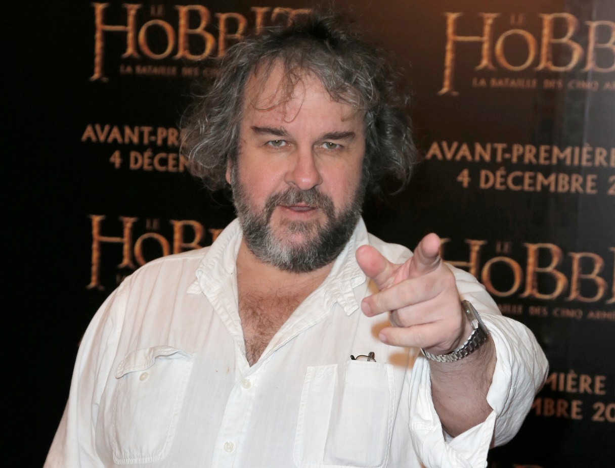 FILE - In this file photo dated Thursday, Dec. 4, 2014, director Peter Jackson poses for photos at the screening of his film The Hobbit. It is announced Monday Jan. 22, 2018, that Jackson is transforming grainy black-and-white archive film from the London Imperial War Museum using cutting-edge digital technology and hand coloring to transform World War I film into 3-D color, to mark the centenary of the 1914-18 conflict. (AP Photo/Francois Mori, FILE)
