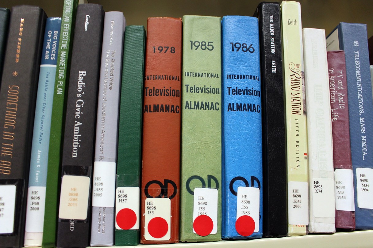 In this Jan. 25, 2018, photo, books marked with red stickers, meaning they might be removed from the shelves, are displayed at the Indiana University of Pennsylvania library in Indiana, Pa. IUP is planning to remove tens of thousands of books that have little or no readership. (AP Photo/Michael Rubinkam)