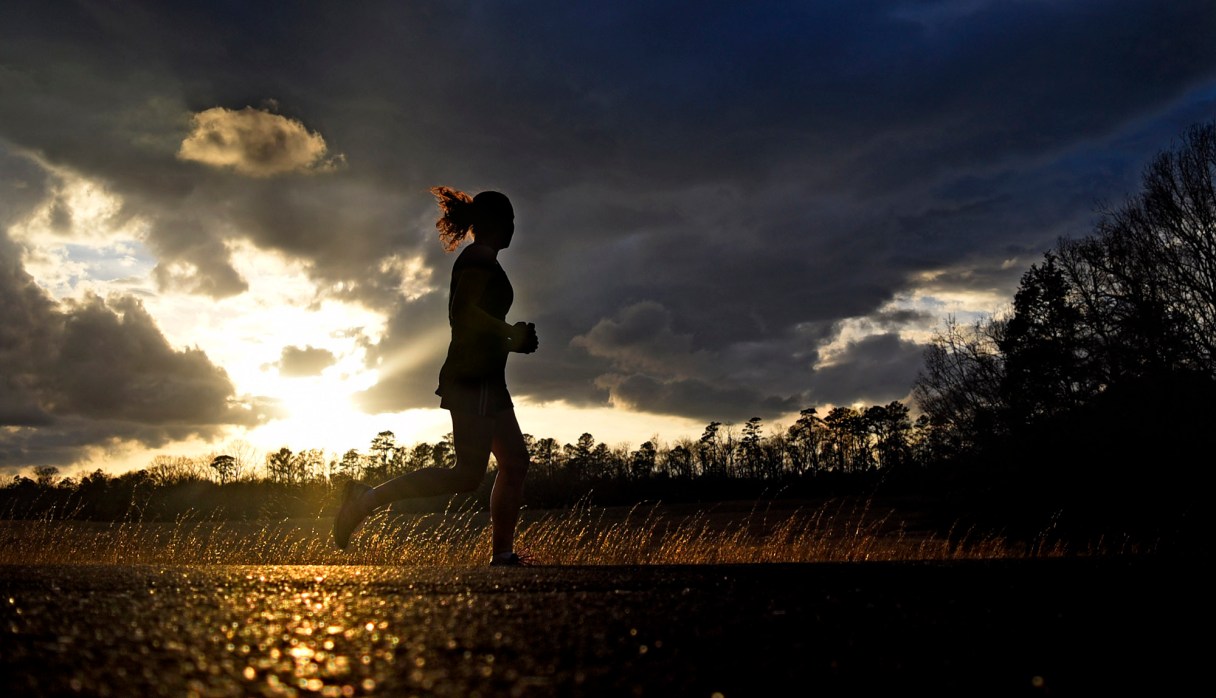 As the sun sets a runner looks to the western sky as she jogs along Glenn-Kelly Road in Chickamauga National Military Park on February 21, 2018.  With the recent warm weather the park's roads have been a haven for athletes of all sorts.