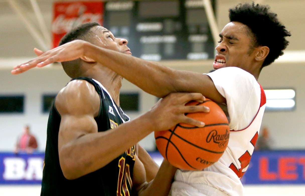 Signal Mountain's Jarren Radden (30) fouls Tyner's Solomon Bridgeman (10) during the Region 3-AA final at Susan Ingram Thurman Gymnasium on the campus of Red Bank High School on Thursday, March 1, 2018 in Red Bank, Tenn.