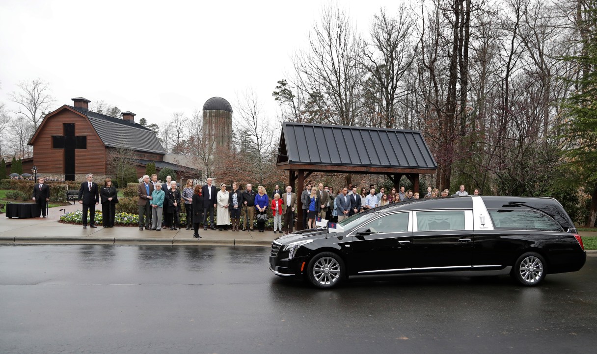 Family members look on as the hearse carrying the body of the Rev. Billy Graham returns to the Billy Graham Library in Charlotte, N.C., Thursday, March 1, 2018. His funeral will be Friday. (AP Photo/Chuck Burton)