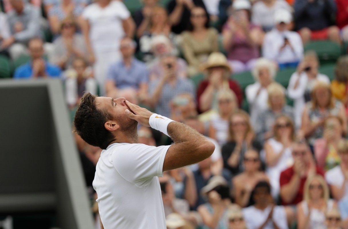 Juan Martin Del Potro of Argentina celebrates defeating Gilles Simon of France in their men's singles match at the Wimbledon Tennis Championships in London, Tuesday July 10, 2018. (AP Photo/Kirsty Wigglesworth)