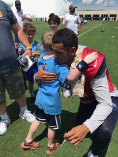 Titans quarterback Marcus Mariota shares a hug with Soddy-Daisy's Nolan Hendricks after Tuesday morning's practice. / Contributed photo by Alan Pressley