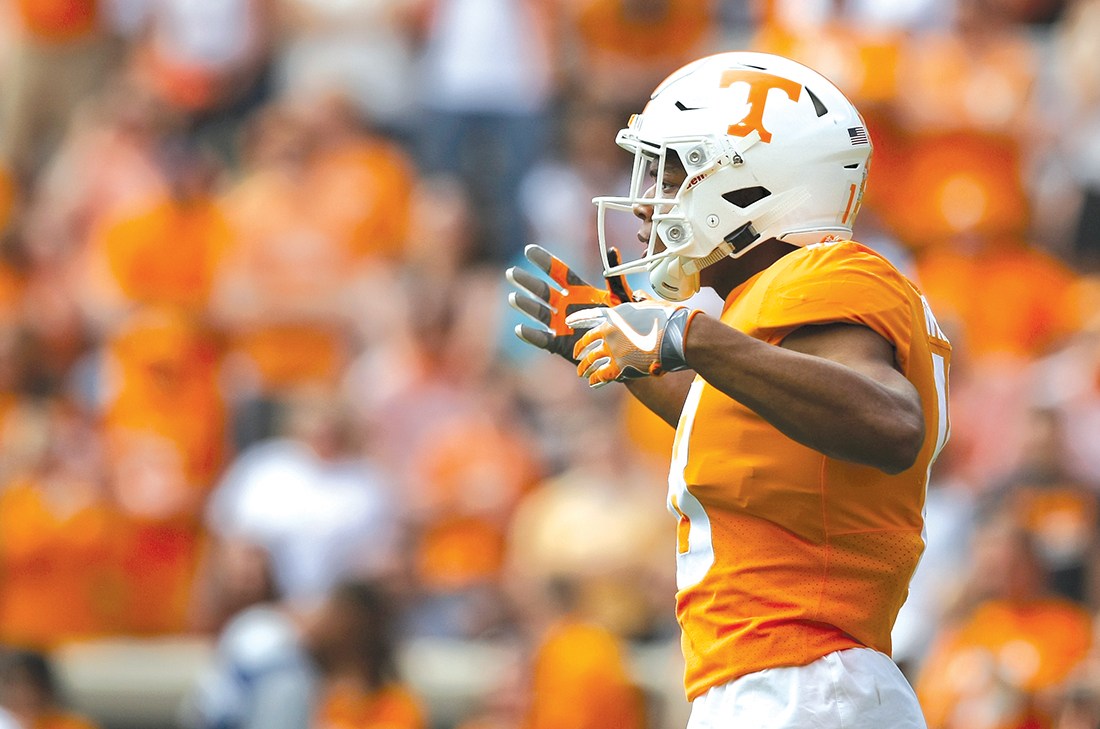 Tennessee defensive back Nigel Warrior pumps up the crowd in Knoxville. (Staff photo by C.B. Schmelter)