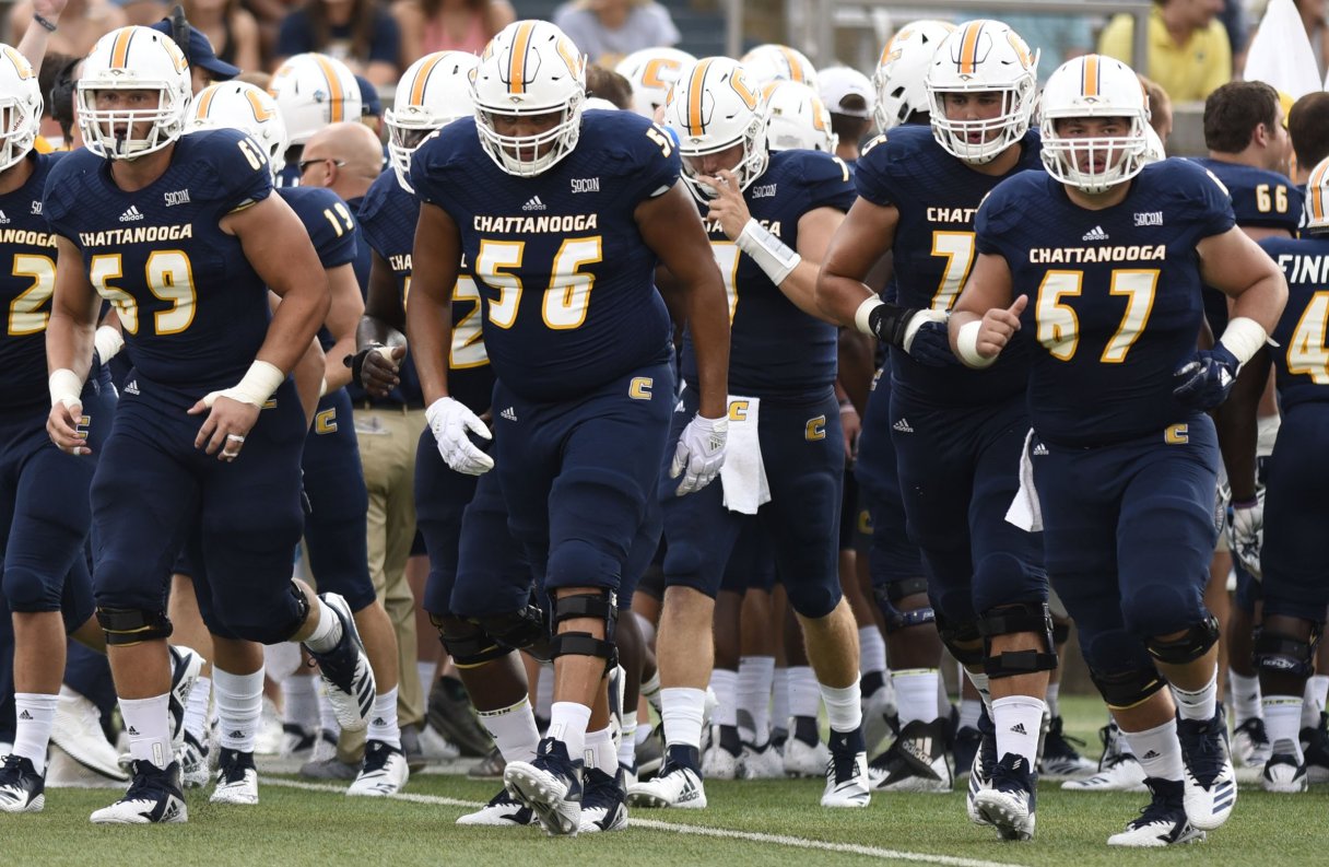 UTC offensive linemen Cole Strange (69), Malcolm White (56) and Noah Ramsey (67) lead the Mocs on the field before their 2018 season opener against Tennessee Tech at Finley Stadium. The offensive line's experience should be a plus in Rusty Wright's first year as head coach.