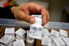New York Times file photo — A pharmacist holds a bottle of oxycodone.