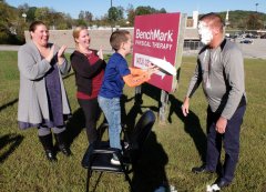 Staff photo by Tim Barber/ Leland Boehning, 6, second from right, delivers a cream pie to the face of Glenn Carlson, PT, DPT at the Soddy-Daisy location of BenchMark Physical Therapy, following the culmination of a bake sale to benefit Rise Against Hunger. From left are Heather Boehning, Morgan Boulware, PT, DPY, OCS, Leland and Carlson.