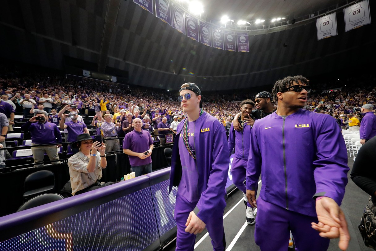 LSU quarterback Joe Burrow, left, and wide receiver Ja'Marr Chase walk into the Pete Maravich Assembly Center during a celebration of their national championship on Saturday in Baton Rouge, La. / AP photo by Gerald Herbert