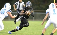 Staff photo by Robin Rudd / Brainerd quarterback Xiyeer Lattimore tries to get outside two McMinn Central defenders on Oct. 29 in the regular-season finale for both teams at Brainerd. The first round of the TSSAA playoffs includes Brainerd's visit to Smith County in Class 3A.