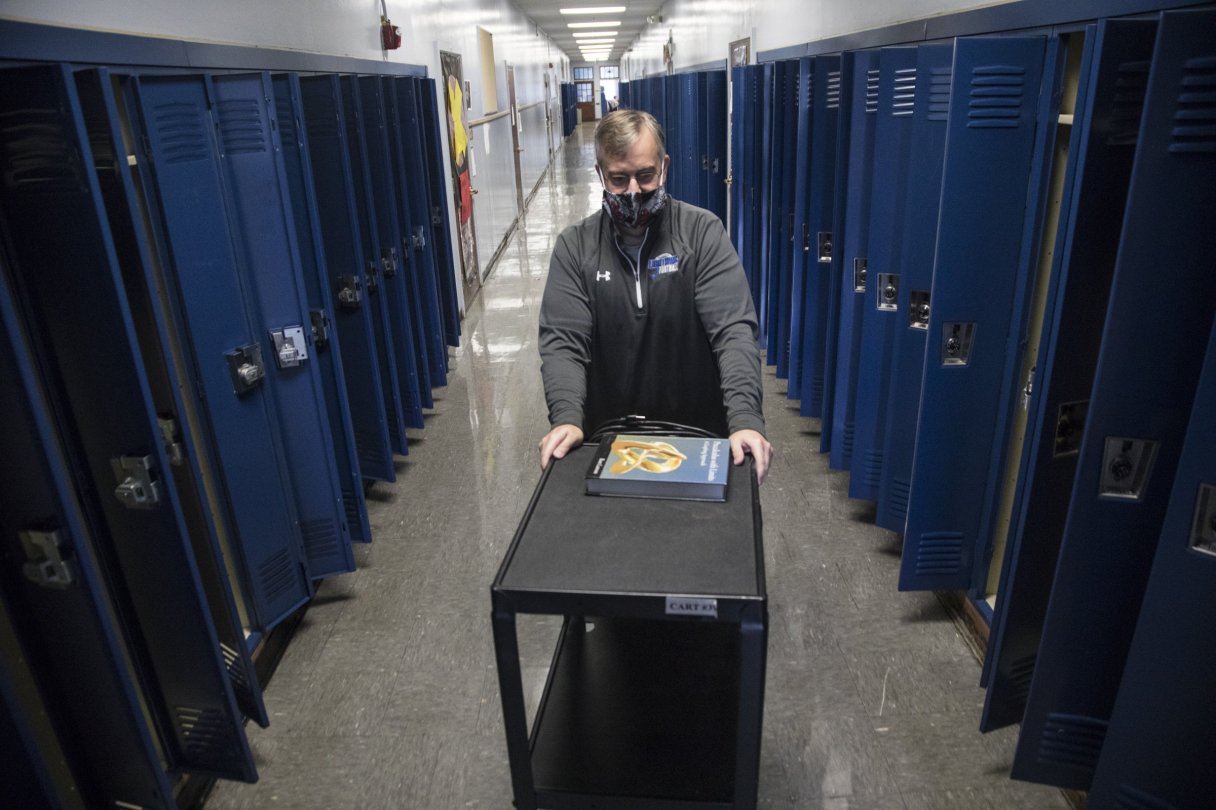 Staff photo by Troy Stolt / Chattanooga School for Arts and Sciences (CSAS) high school math teacher Bill Bowser pushes a cart down a hallway on the third floor of the school on Wednesday, May 13, 2020 in Chattanooga, Tenn.