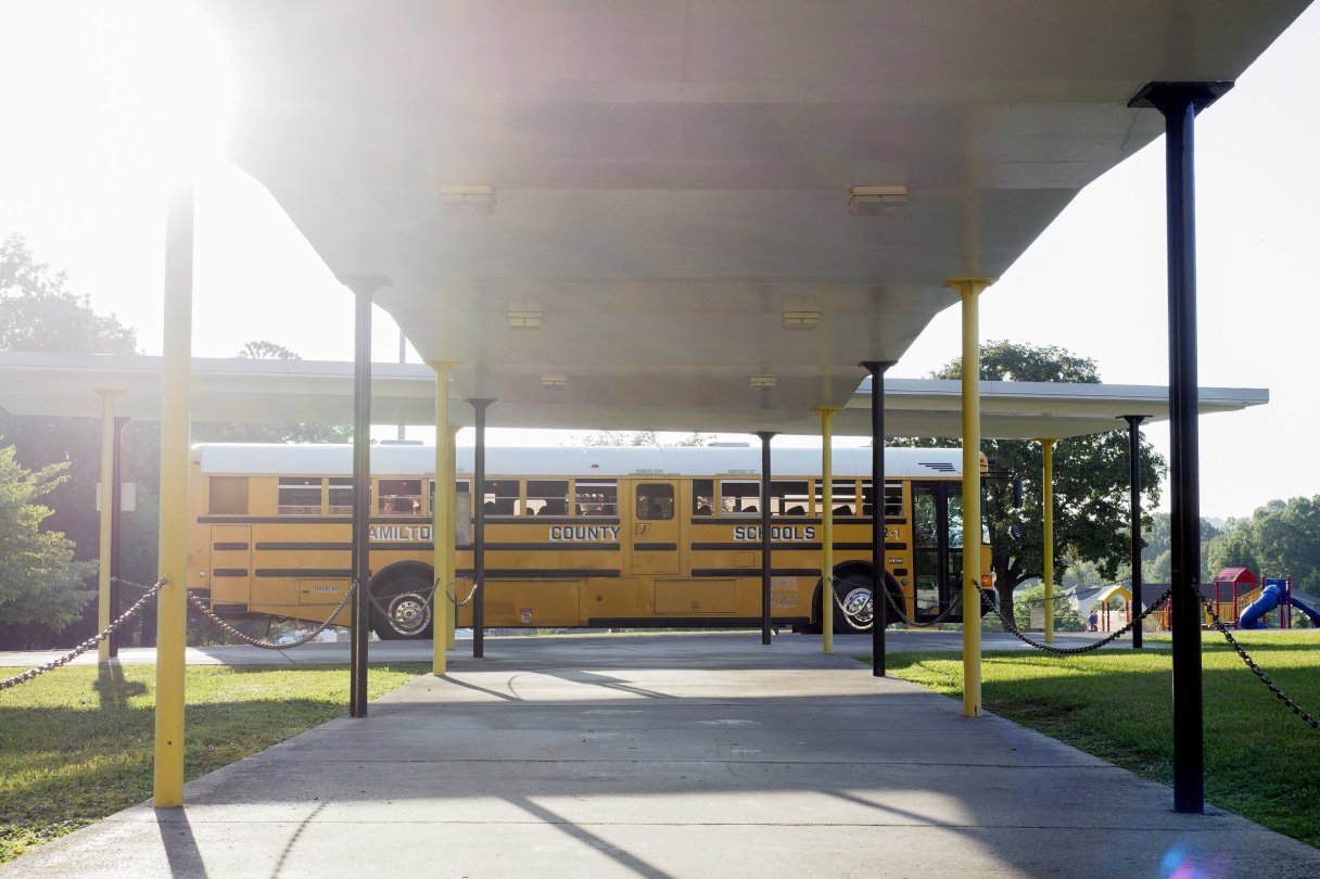 Staff photo by C.B. Schmelter / A school bus waits to drop off students at the front entrance on the first day of school at Hixson Elementary School on Wednesday, Aug. 12, 2020 in Hixson, Tenn. Hamilton County Schools will enter phase 3 of its reopening plan next week, bringing most students back to the classroom.