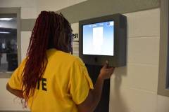 An inmate uses the kiosk system, now available for requests, grievances or commissary orders. / Photo provided by Hamilton County Sheriff's Office.