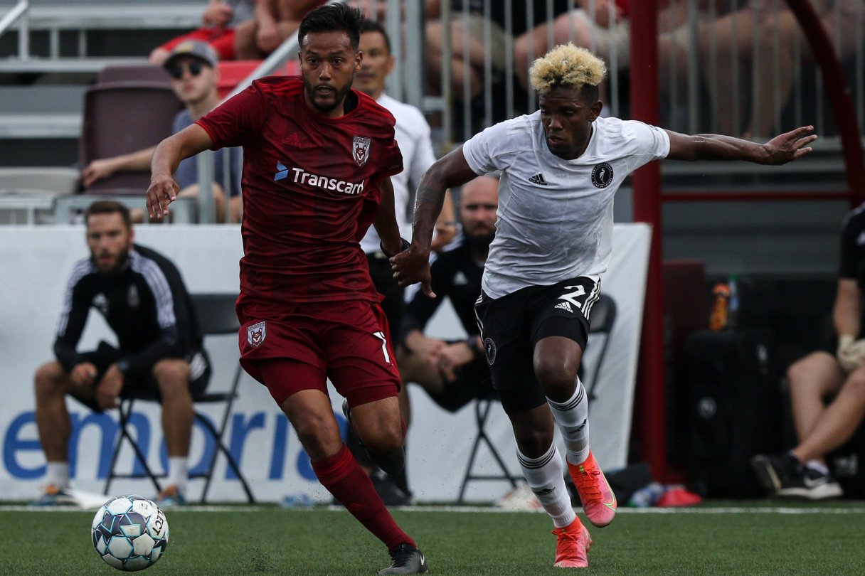Staff photo by Troy Stolt / Chattanooga Red Wolves midfielder Josue Espana, left, gets around a Fort Lauderdale CF defender during a USL League One match on May 22 at CHI Memorial Stadium in East Ridge.