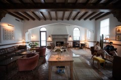 Staff photo by Troy Stolt / With its wooden beams, large fireplace and terra cotta floors, the first floor is meant to feel like an Italian lodge. "The fireplaces - there's nothing more homey than a fireplace that burns wood," Common House co-founder and Chief Creative Officer Derek Sieg says, listing one of his favorite things about the Chattanooga location.