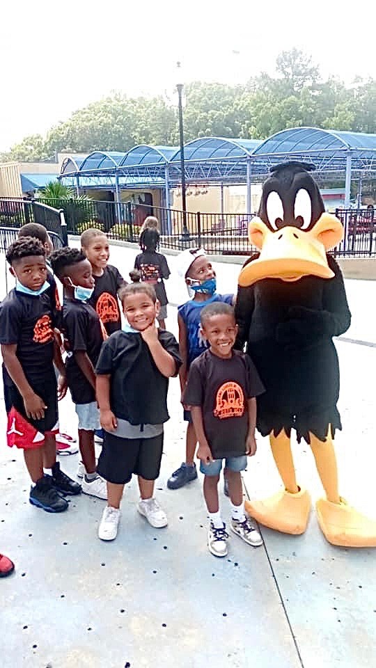 Contributed photo / Daffy Duck greets a few of the children who benefited from a joint fundraiser between Kids Art Box and Reach One Teach One. The money allowed 50 students from underserved communities to visit Six Flags in Atlanta.