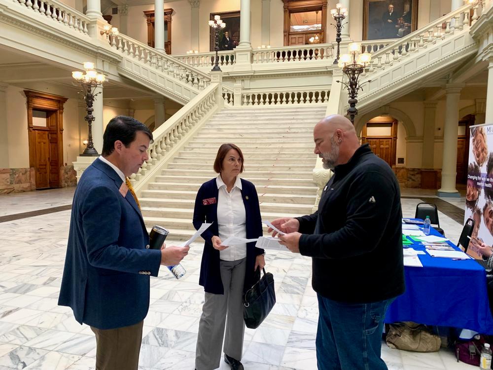Georgia Public Broadcasting file photo / Jonathan Langston, right, speaks with Reps. Matthew Gambill and Angelika Kausche at the Georgia Capitol.