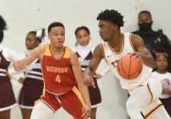 Staff photo by Matt Hamilton / Tyner's Nehemiah Bloodsaw drives as Howard's Jadon Jenkins defends during Saturday's game at Tyner.