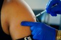 FILE - A Jackson, Miss., resident receives a Pfizer booster shot from a nurse at a vaccination site Feb. 8, 2022. The Biden administration hopes to make getting a COVID-19 booster as routine as going in for the yearly flu shot. (AP Photo/Rogelio V. Solis, File)