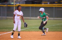 Staff photo by Olivia Ross / East Hamilton High's Henley Apps runs to 3rd as Chelsea Paris of Hixson calls out to a team member on March 22, 2022. Hixson High School took on East Hamilton at home.