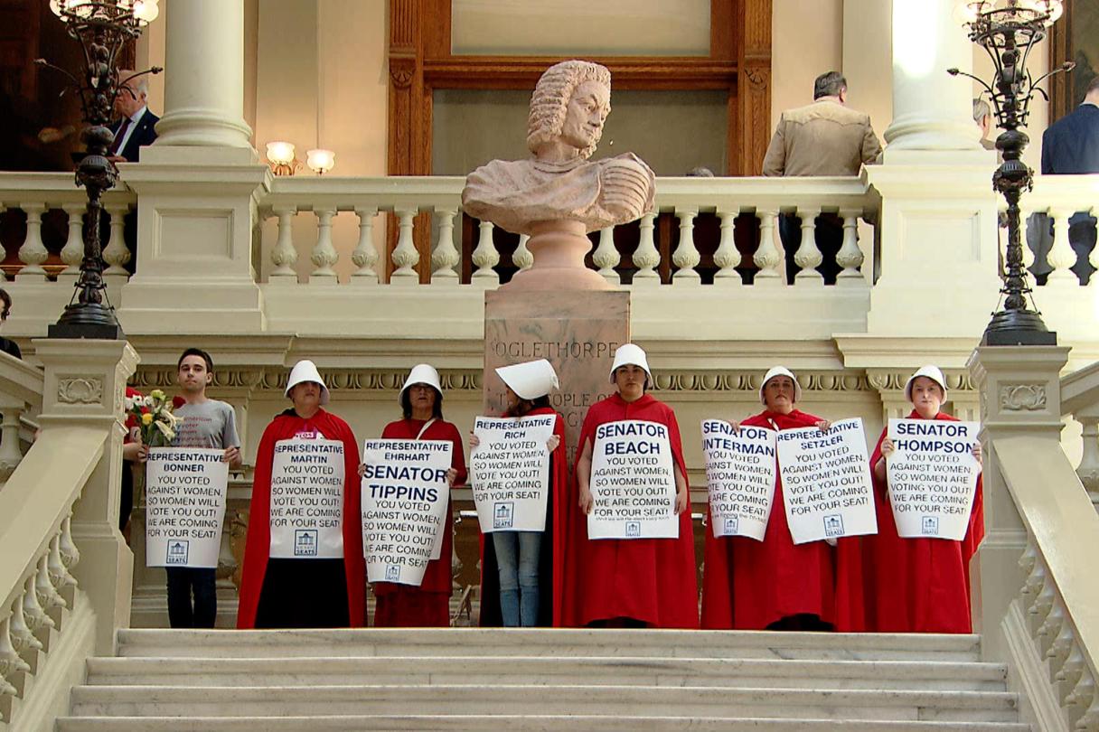 Georgia Public Broadcasting / Protesters hold an April 2019 demonstration in the state Capitol against Georgia's "heartbeat bill," HB 481, in costumes reminiscent of those in the TV series "The Handmaid's Tale," which is set in a future without abortion rights. On Friday, a Supreme Court decision overturned Roe v. Wade's protections of abortion rights.