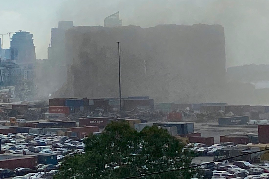 Dust covers the silos damaged during the August 2020 massive explosion in the port, after part of it collapsed, in Beirut, Lebanon, Sunday, July 31, 2022. A section of Beirut's massive port grain silos, shredded in the 2020 explosion, collapsed on Sunday after a weekslong fire triggered by grains that had fermented and ignited in the summer heat. (AP Photo/Mohammed Anouti)
