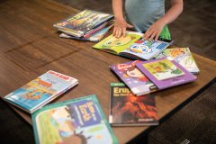 Staff photo by Troy Stolt / Lael Marx, 5, flips through the pages of a book inside of the children's section of the Chattanooga Public Library on Monday, May 3, 2021 in Chattanooga, Tenn. Monday, the library reopened to the general public for daily service, after more than a year in which many of its services had been unavailable to promote social distancing in an effort to stop the spread of COVID-19.