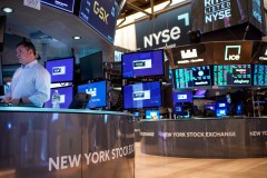 FILE - Traders work on the floor at the New York Stock Exchange in New York, Aug. 10, 2022. Stocks are opening lower on Wall Street, continuing to add to their losses following a drop last week as traders realized how determined the Federal Reserve is to keep interest rates high to fight inflation. (AP Photo/Seth Wenig, File)