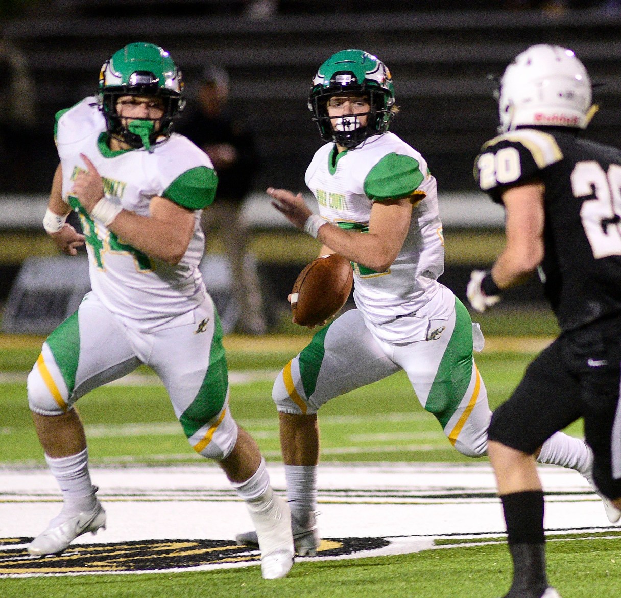 Staff photo by Robin Rudd / Rhea County's Ethan Davis, center, follows the blocking of Hunter Crowe during a game at Bradley Central in October 2021.
