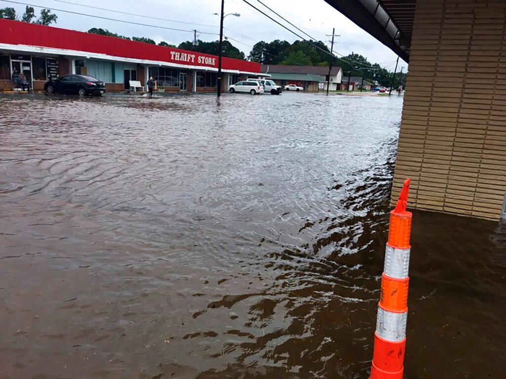 In this photo provided by Pastor Bryant May, rain water covered Bierdeman Road in Pearl, Miss., Wednesday, Ag. 24, 2022. Several buildings on the street were flooded, including an outlet store and a church. (Pastor Bryant May via AP)