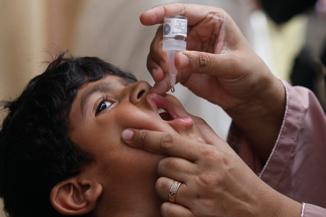 FILE - A health worker gives a polio vaccine to a child in Karachi, Pakistan, May 23, 2022. British health authorities on Wednesday, Aug. 10 say they will offer a polio booster dose to children aged 1 to 9 in London, after finding evidence the virus has been spreading in multiple regions of the capital, despite not confirming any cases of the paralytic disease in people. (AP Photo/Fareed Khan, file)