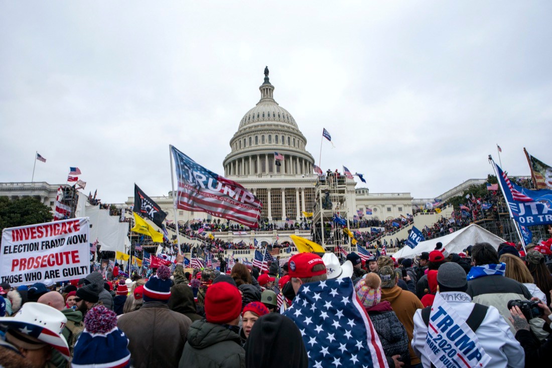 FILE - Rioters loyal to President Donald Trump rally at the U.S. Capitol in Washington on Jan. 6, 2021. The House committee investigating the Jan. 6 attack on the U.S. Capitol has scheduled its next hearing for Oct. 13, 2022, pushing the investigation back into the limelight less than three weeks before the midterm election that will determine control of Congress. (AP Photo/Jose Luis Magana, File)