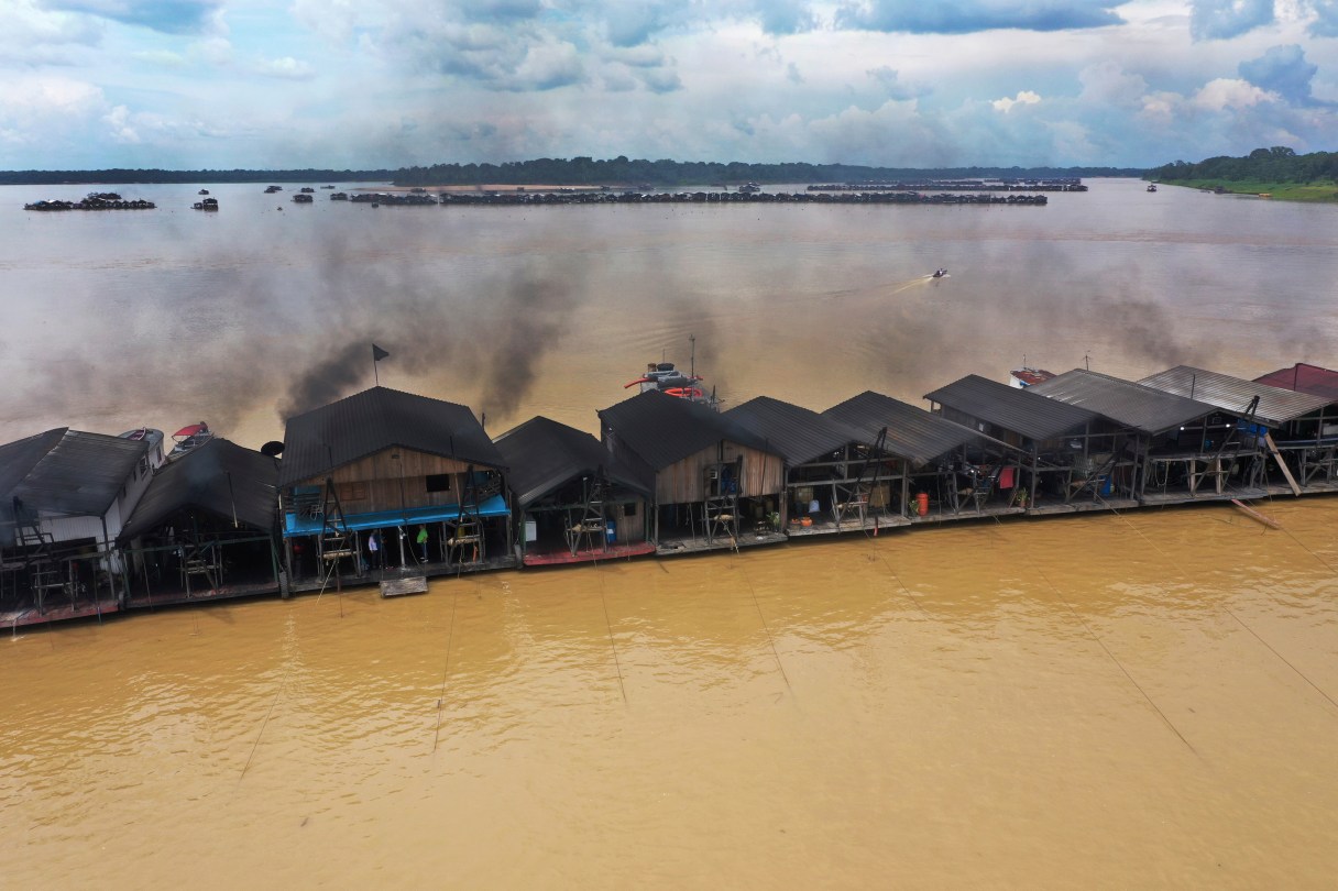 Dredging barges operated by miners illegally mining gold converge on the Madeira River, a tributary of the Amazon river in Autazes, Amazonas state, Brazil, Nov. 25, 2021. (AP Photo/Edmar Barros, File)