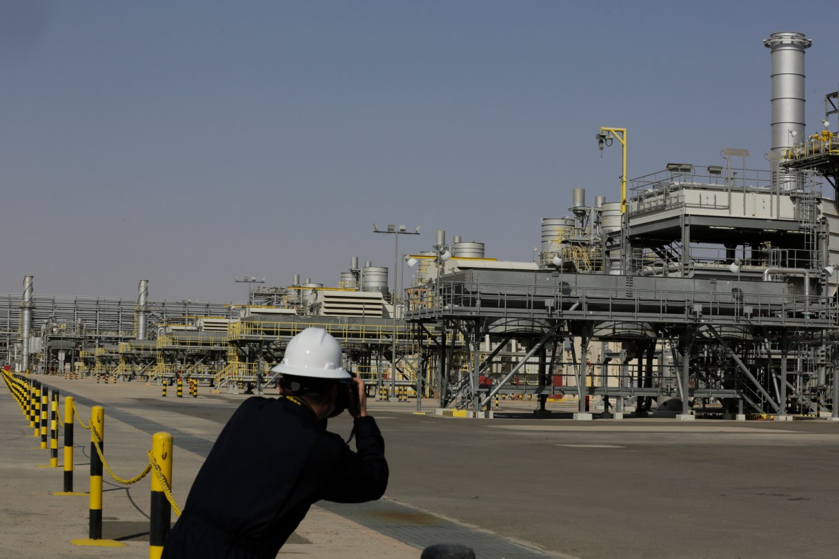 A photographer takes pictures of the Khurais oil field during a tour for journalists, 150 km east-northeast of Riyadh, Saudi Arabia, June 28, 2021. (AP Photo/Amr Nabil, File)