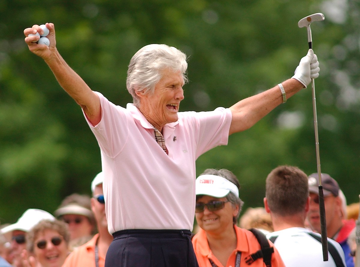 Kathy Whitworth responds to the crowd as she prepares to tee off during the Tournament of Champions golf tournament at Locust Hill Country Club in Pittsford, N.Y. on June 20, 2006. Former LPGA Tour player Whitworth, whose 88 victories are the most by any golfer on a single professional tour, died on Saturday, Dec. 24, 2022, night, her longtime partner said. She was 83. (Carlos Ortiz/Democrat & Chronicle via AP, File)
