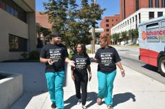 Contributed Photo by Miles Huff / Cempa staff members, from left, Chris Mathis, Kia Ruffin and Aisha McGee walk along the sidewalk outside Cempa Community Care in Chattanooga wearing shirts promoting PrEP, a drug that prevents the spread of HIV to those who are not infected. Cempa’s PrEP services are in jeopardy after Tennessee announced an end to the grant that supports those services.