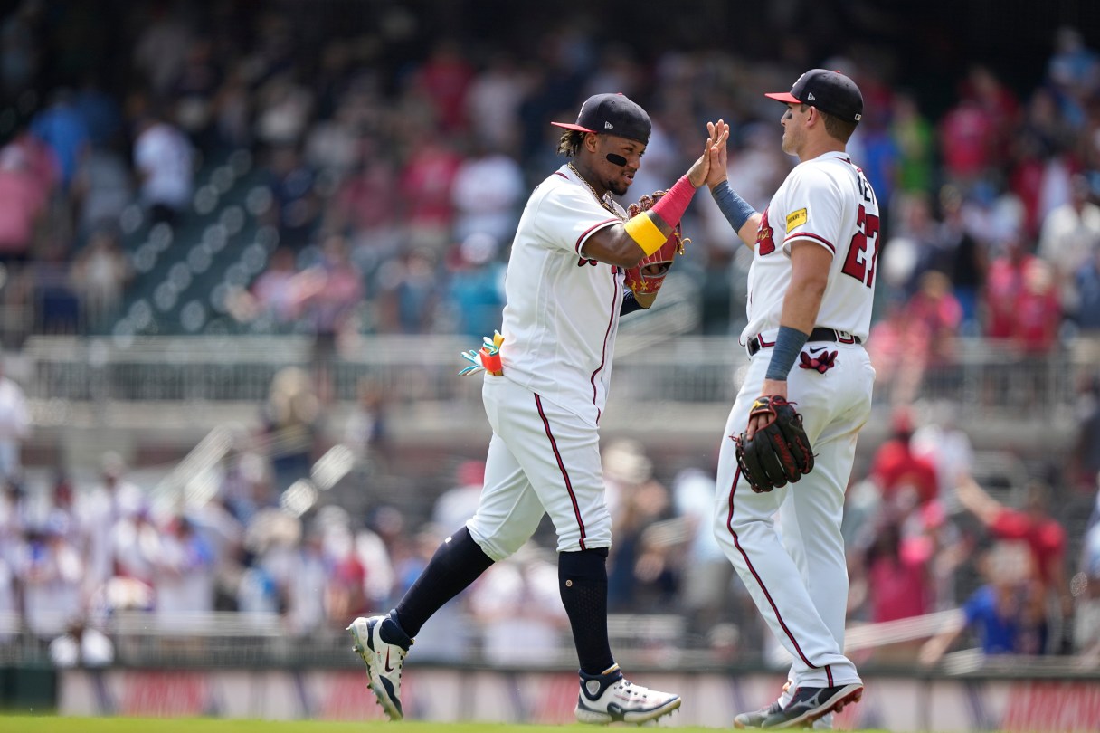 Atlanta Braves' Ronald Acuna Jr., left, celebrates with Austin Riley, right, after a win against the Los Angeles Angels, Wednesday, Aug. 2, 2023, in Atlanta. (AP Photo/Brynn Anderson)
