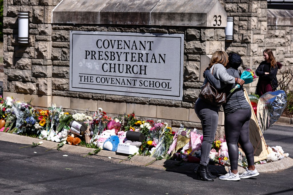 Two women hug near a memorial at the entrance to The Covenant School on March 29 in Nashville. The Tennessee Court of Appeals heard arguments Monday on whether Tennessee law gives the parents of school shooting victims the right to have a say over which police records are released to the public. (AP Photo/Wade Payne, File)