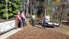 Contributed Photo / Officials, including Cody Roney, right, executive director of the Lula Lake Land Trust, gather at the Far Enough Trail, part of the Lookout Mountain Conservancy. Multiple organizations cooperated to make the approximately 34-mile River to Clouds Route a reality.