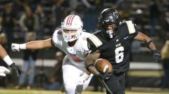 Staff photo by Matt Hamilton/ Bradley Central's Boo Carter tries to escape an Oakland tackle in the TSSAA Class 6A semifinal game November 24. Carter and teammate Marcus Goree are enrolling early at the University of Tennessee.