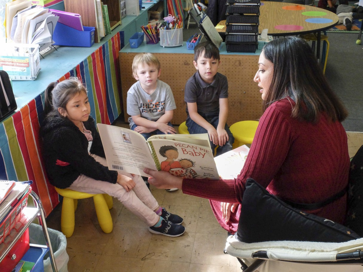 Time Free Press File Photo / Cynthia Lopez, Michael Neal and Christian Candelaria, from left, listen as Dupont Elementary School teacher Sonal Patel reads to them on Nov. 22, 2019.